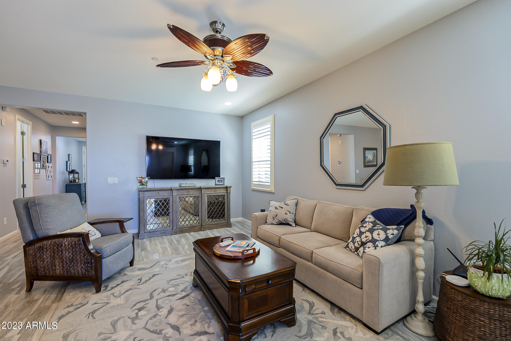 13719 West Linanthus Road Peoria, AZ 85383 - Photo 2 of 38 a living room with furniture a flat screen tv and a window