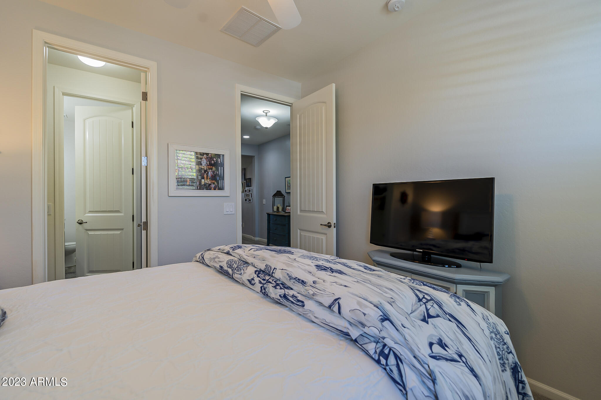 13719 West Linanthus Road Peoria, AZ 85383 - Photo 21 of 38 a bedroom with a flat screen tv and a bed