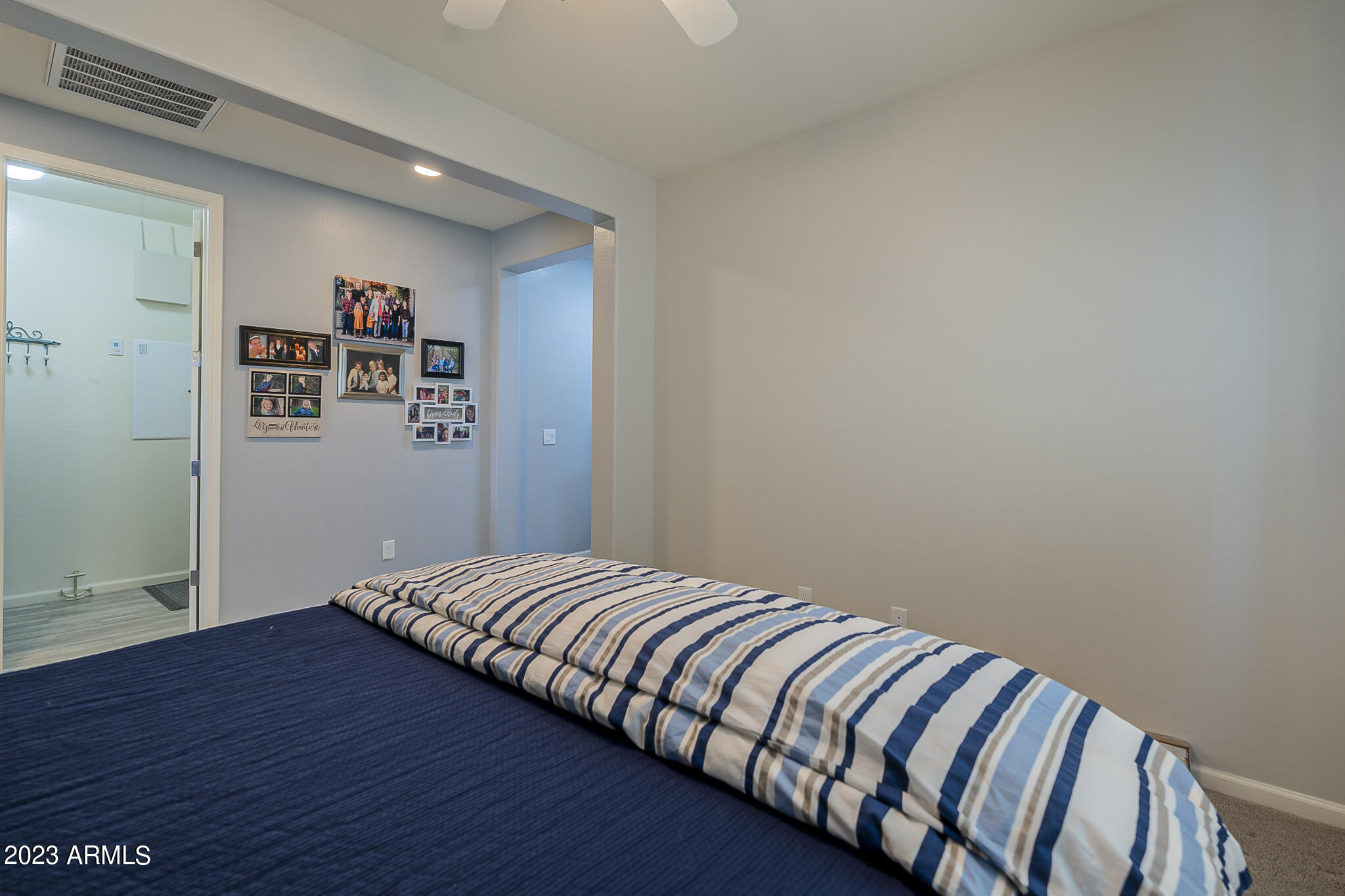 13719 West Linanthus Road Peoria, AZ 85383 - Photo 26 of 38 a bedroom with a bed and wooden floor