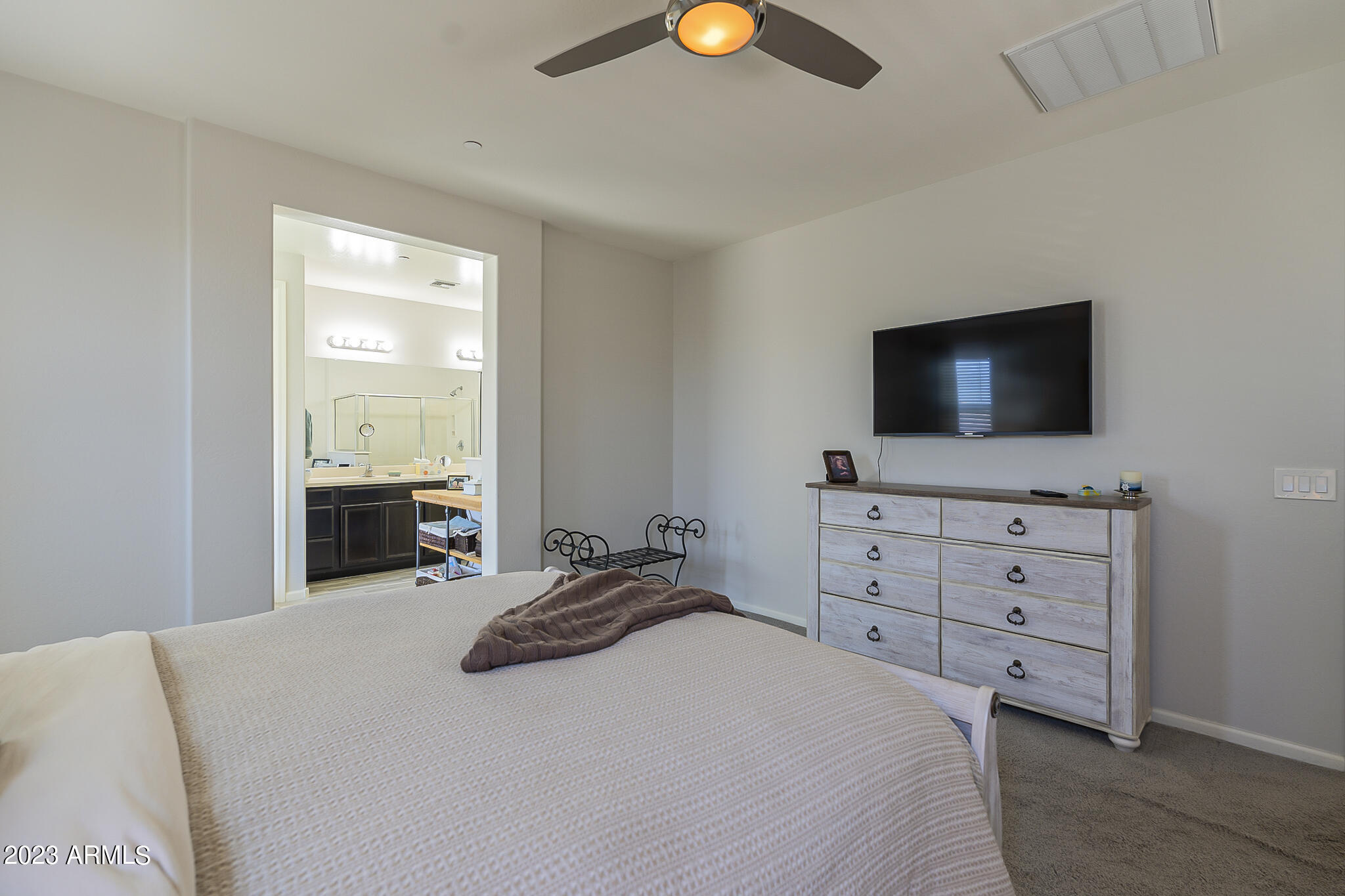 13719 West Linanthus Road Peoria, AZ 85383 - Photo 29 of 38 a bedroom with a bed and a flat screen tv