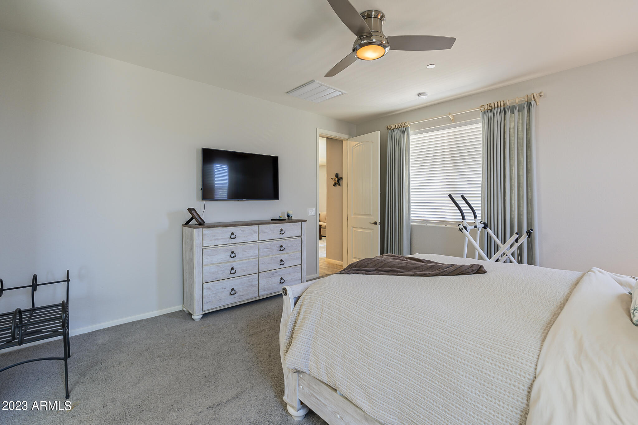 13719 West Linanthus Road Peoria, AZ 85383 - Photo 30 of 38 a bedroom with furniture and flat screen tv