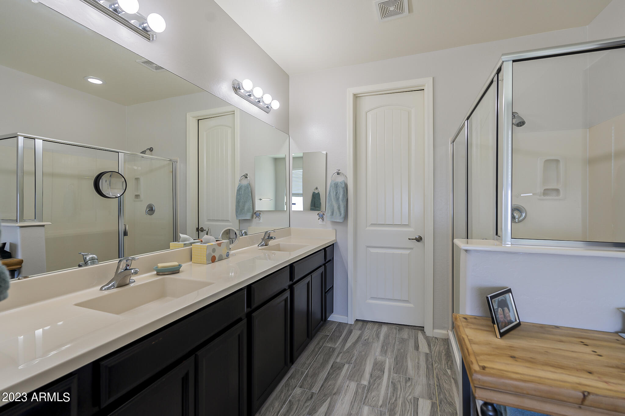 13719 West Linanthus Road Peoria, AZ 85383 - Photo 6 of 38 a bathroom with a double vanity sink a mirror and a shower
