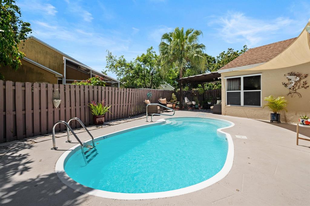 39 Teal Way Boynton Beach, FL 33436 - Photo 20 of 25 a view of a swimming pool with a patio