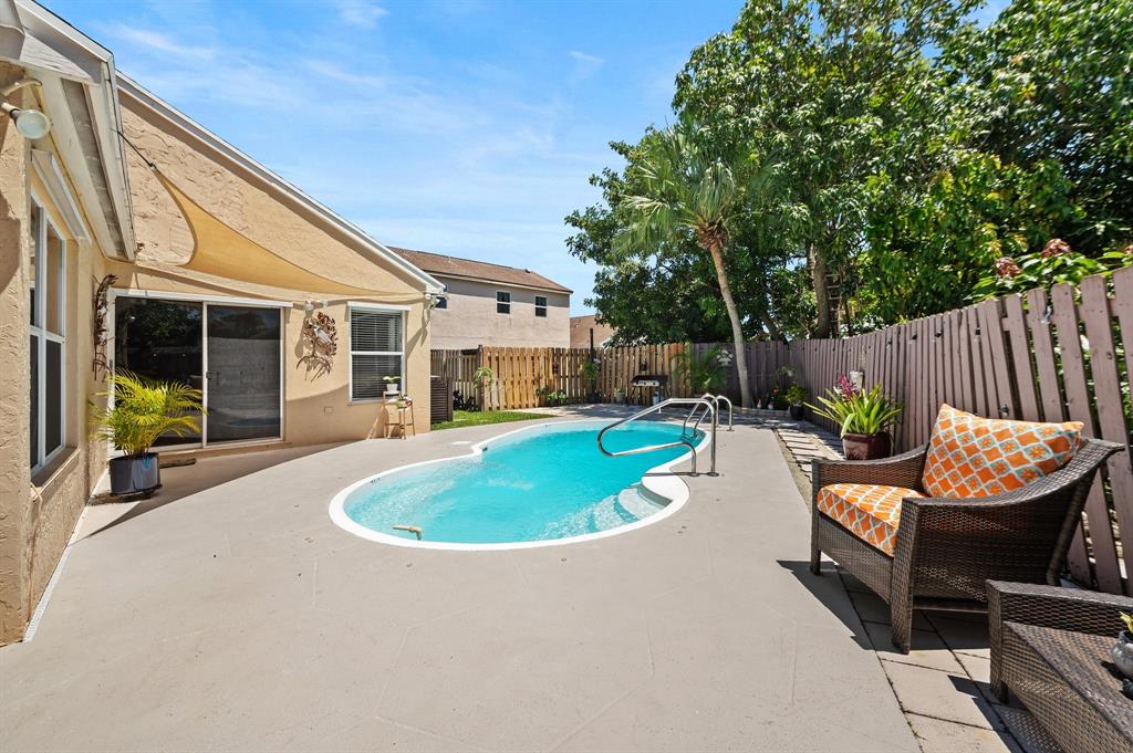 39 Teal Way Boynton Beach, FL 33436 - Photo 21 of 25 a swimming pool with outdoor seating and yard