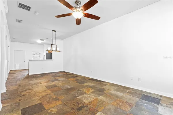 a view of a kitchen with a sink and a ceiling fan