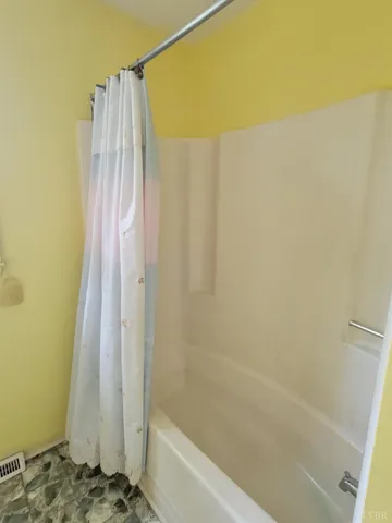 a bathroom with a shower curtain and a sink