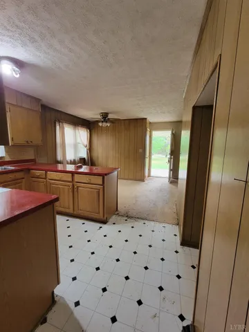 a kitchen with stainless steel appliances a sink a stove a refrigerator and cabinets