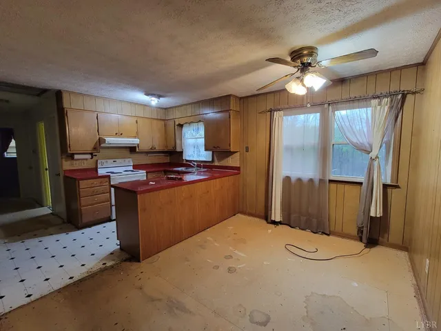 a kitchen with stainless steel appliances a refrigerator sink and microwave