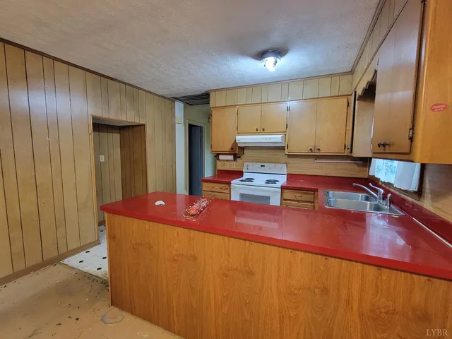 a kitchen with sink cabinets and stove