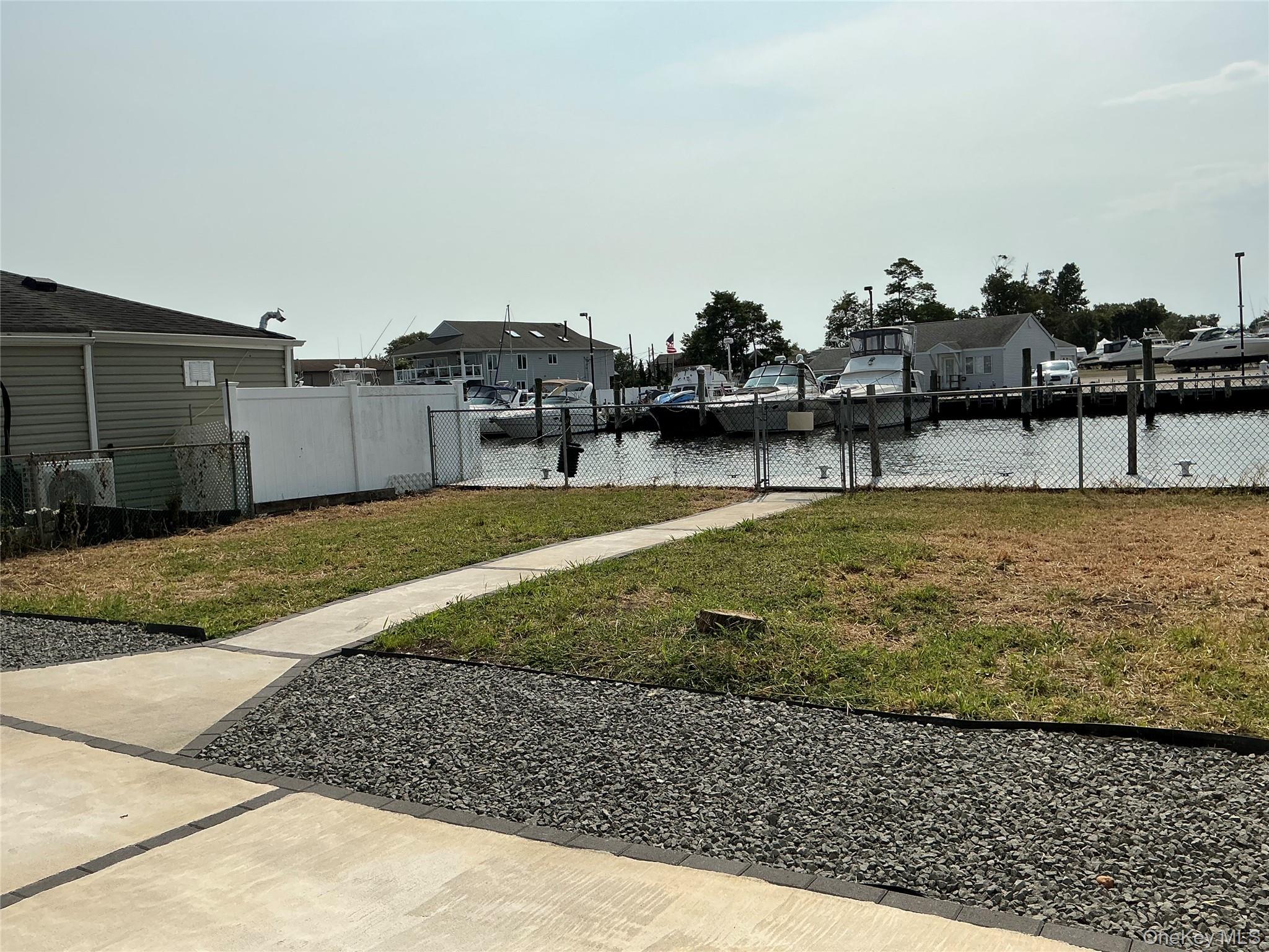 248 East Shore Road Lindenhurst, NY 11757 - Photo 11 of 46 View of yard with a water view, a residential view, and a gate