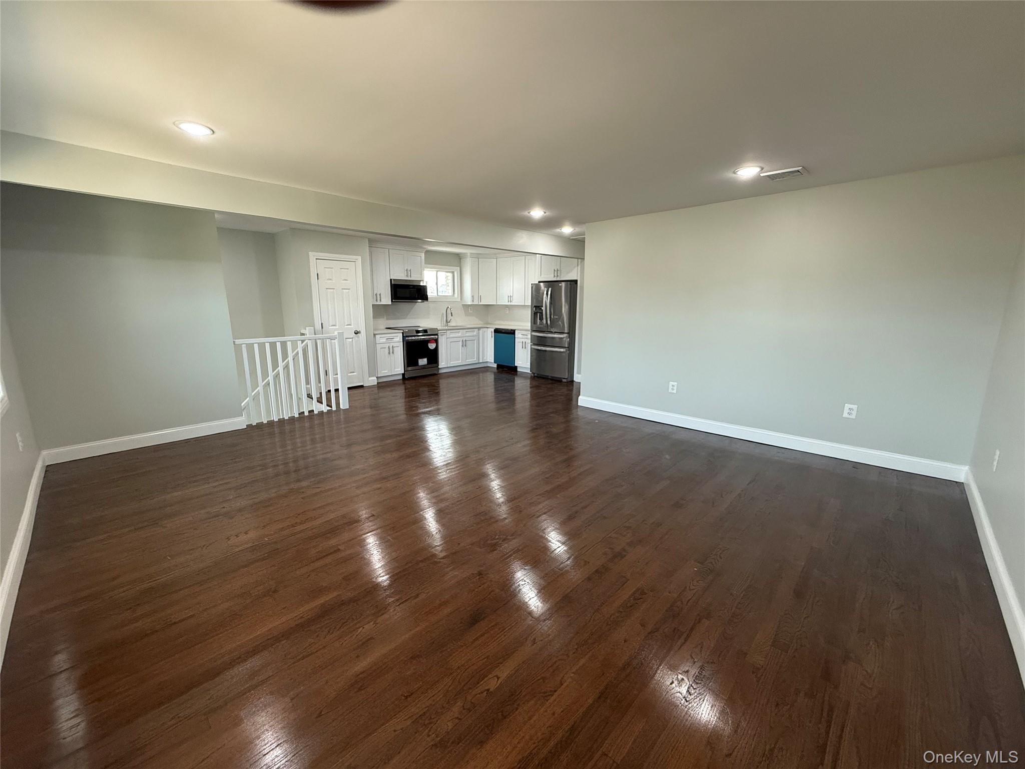 248 East Shore Road Lindenhurst, NY 11757 - Photo 15 of 46 Unfurnished living room with dark wood-type flooring and recessed lighting