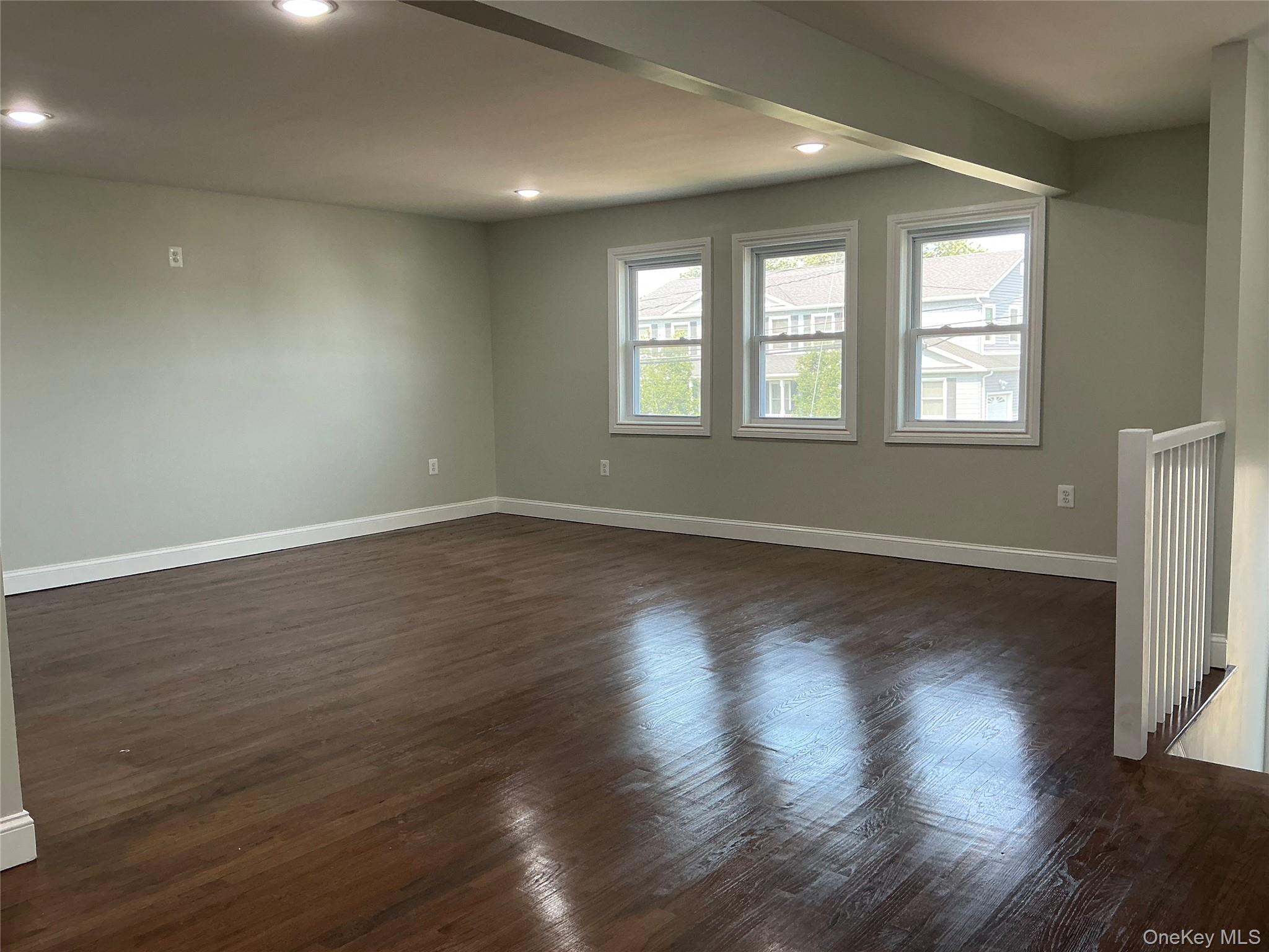 248 East Shore Road Lindenhurst, NY 11757 - Photo 18 of 46 Empty room with dark wood finished floors and recessed lighting