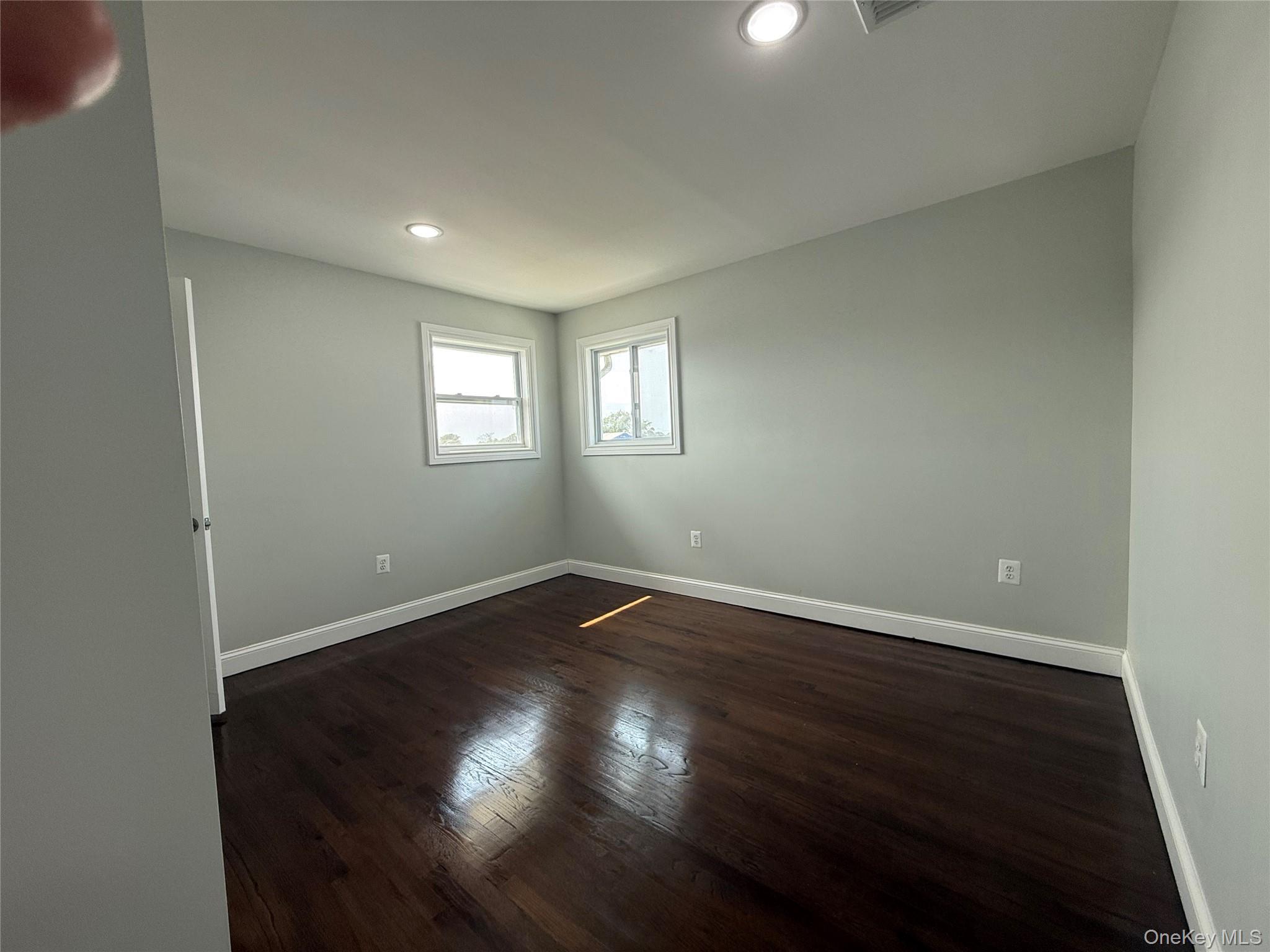 248 East Shore Road Lindenhurst, NY 11757 - Photo 26 of 46 Spare room with dark wood-type flooring and recessed lighting
