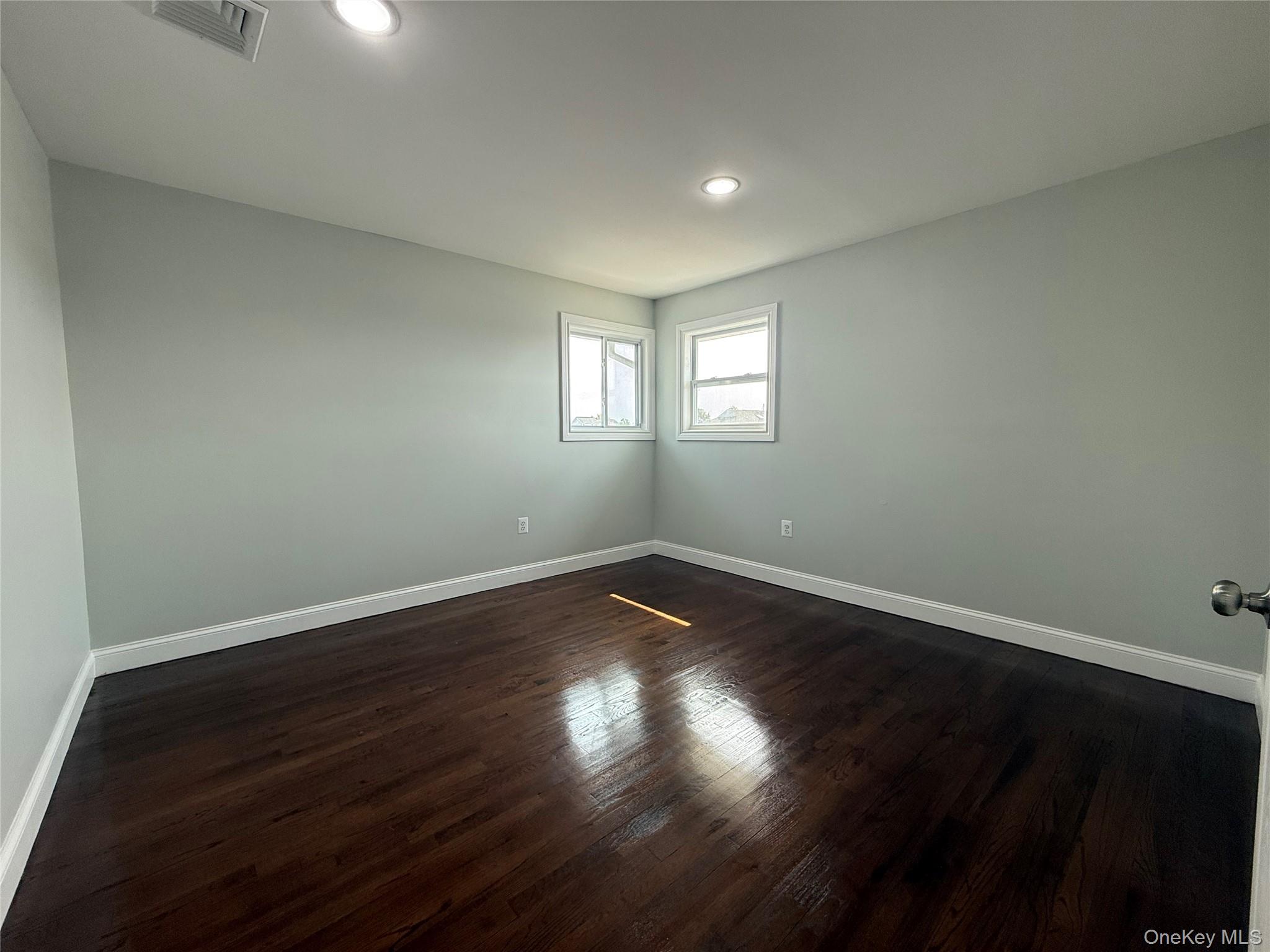 248 East Shore Road Lindenhurst, NY 11757 - Photo 27 of 46 Spare room featuring dark wood-type flooring and recessed lighting