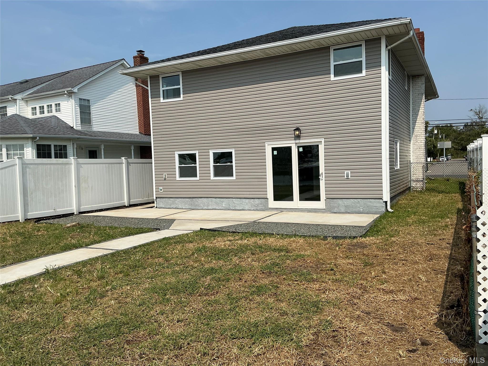 248 East Shore Road Lindenhurst, NY 11757 - Photo 33 of 46 Back of property with a patio area and a chimney