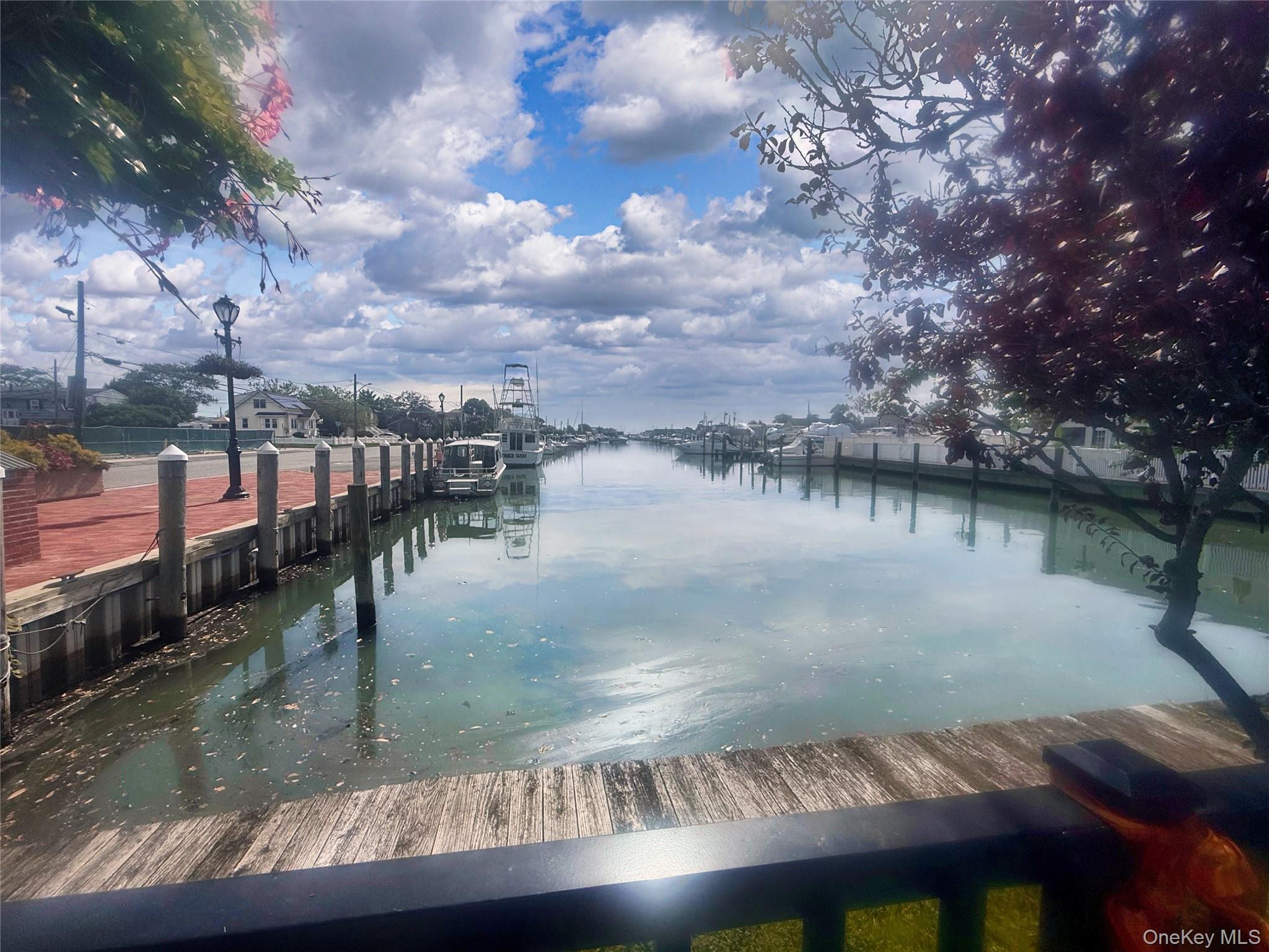248 East Shore Road Lindenhurst, NY 11757 - Photo 45 of 46 Dock area featuring a water view