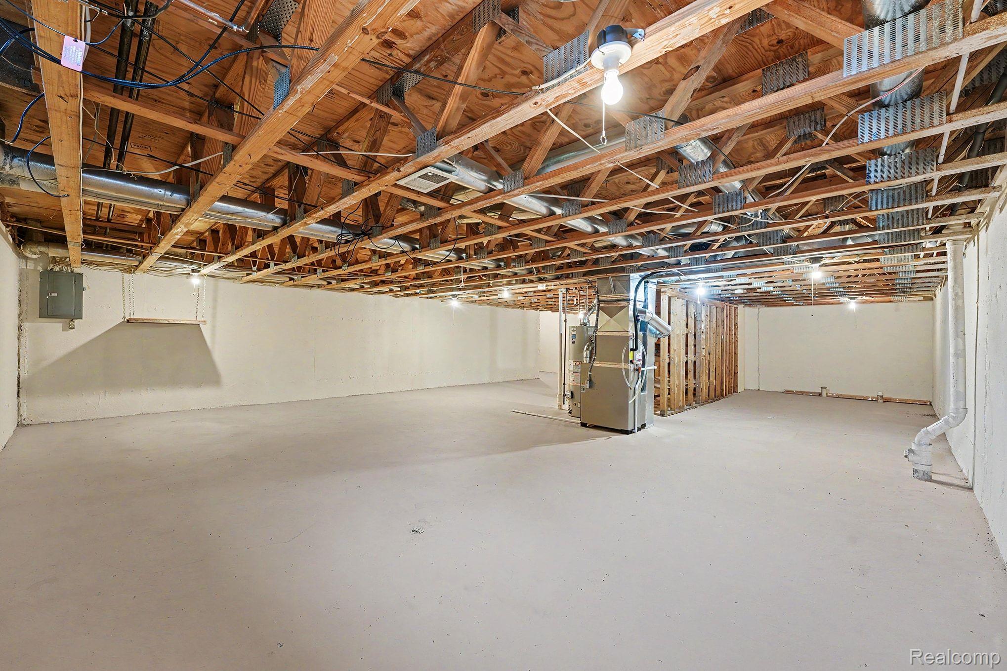 42619 Cedar Ridge Drive Clinton Township, MI 48038 - Photo 14 of 18 Spacious unfinished basement with exposed wood joists and concrete flooring