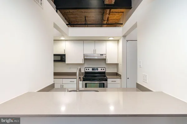 a kitchen with stainless steel appliances granite countertop a stove and a refrigerator