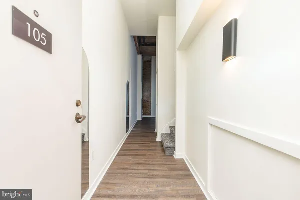 a view of a hallway with wooden floor