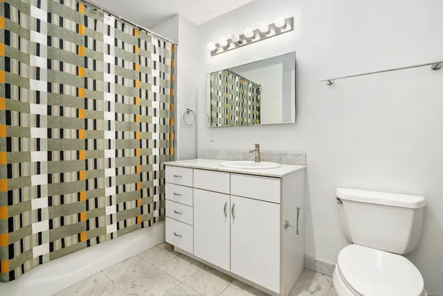 a bathroom with a sink a toilet and mirror