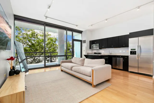 a living room with furniture tv and a large window