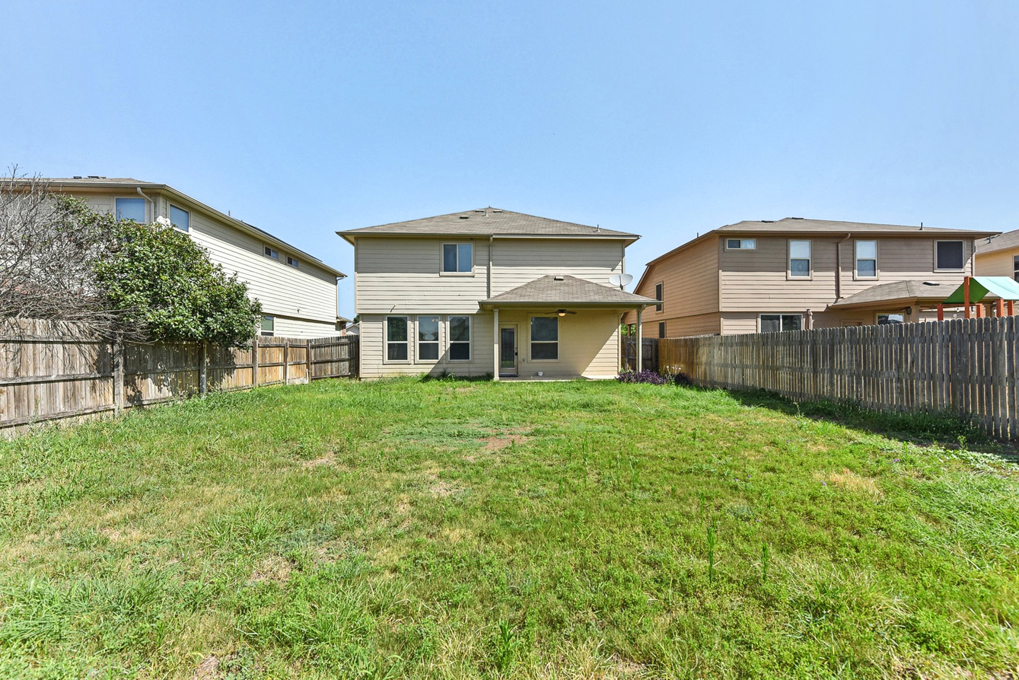 310 Potters Peak Way Georgetown, TX 78626 - Photo 20 of 21 Expansive grass lawn bordered by a wood privacy fence