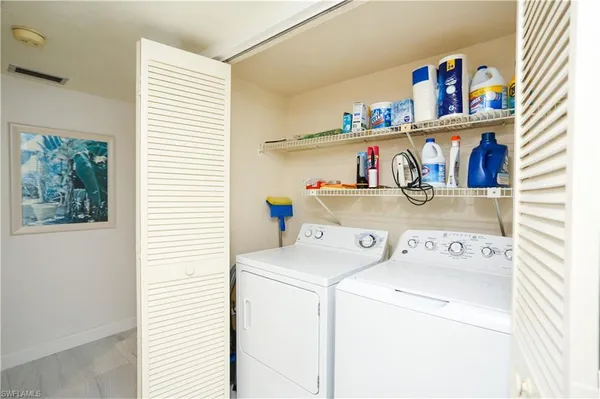 a kitchen with a refrigerator and a stove top oven