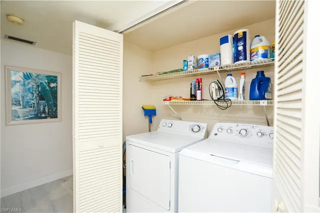 a kitchen with a refrigerator and a stove top oven
