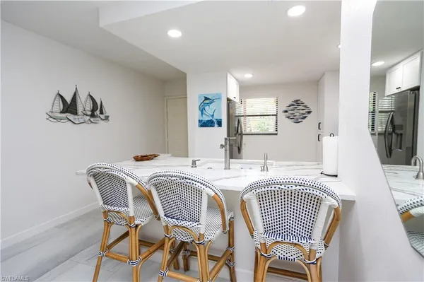 a dining room with furniture and a large window