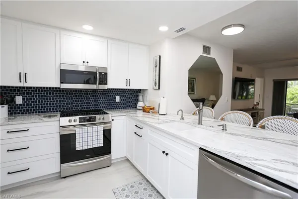 a kitchen with a refrigerator and a sink