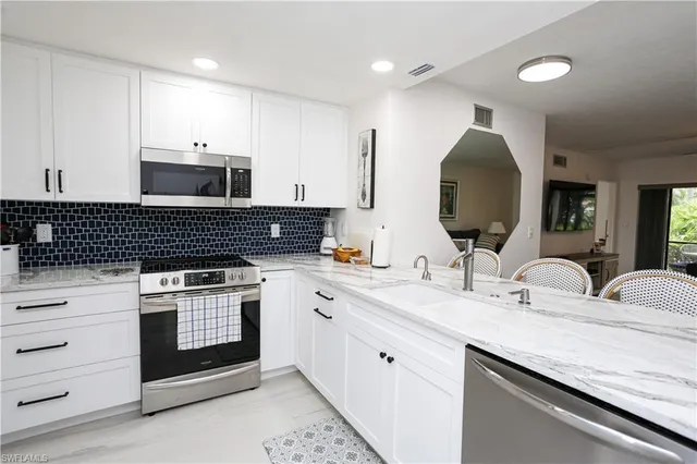a kitchen with a refrigerator and a sink