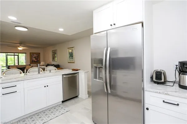 a kitchen with a sink appliances and cabinets