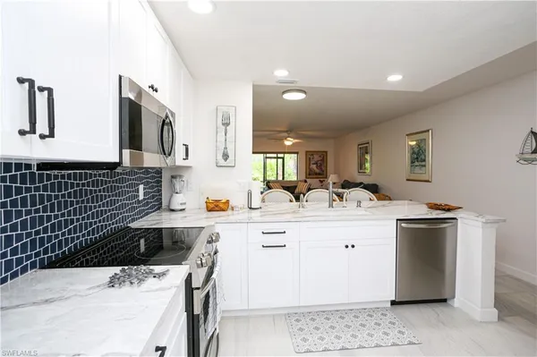 a view of a kitchen with a refrigerator and window