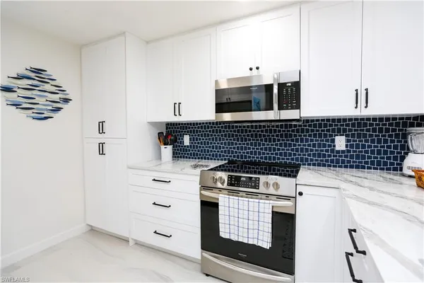 a living room with furniture a flat screen tv and a large window
