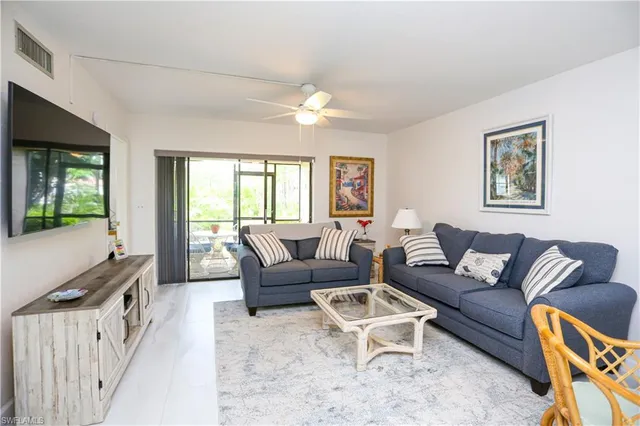 a view of a dining room with furniture and a large window