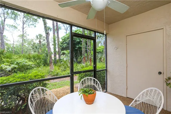 a bedroom with a bed a computer on the desk and a window