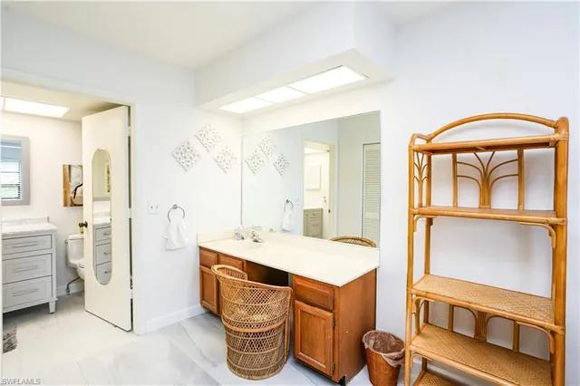 a bedroom with furniture and a flat screen tv