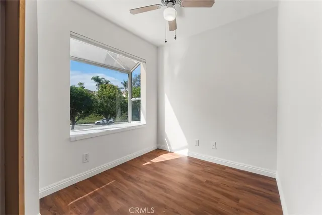 a view of storage and utility room with wooden floor