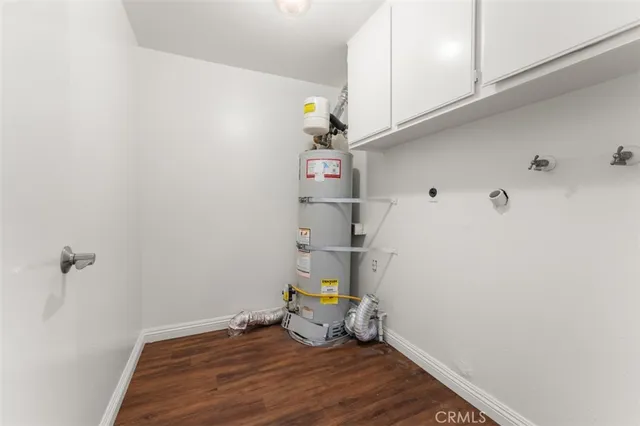 a bathroom with a granite countertop toilet and a sink