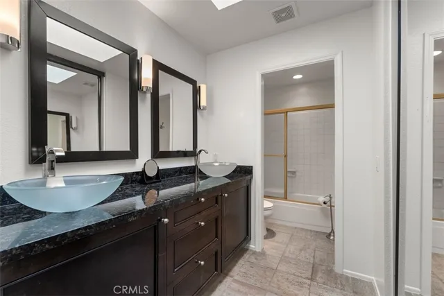 a bathroom with a shower a toilet and a shower