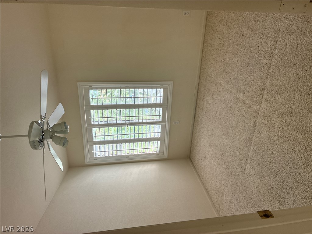 5272 Island Chain Road Las Vegas, NV 89118 - Photo 31 of 39 A well-lit bedroom offering a ceiling fan and plush carpeting for comfort.