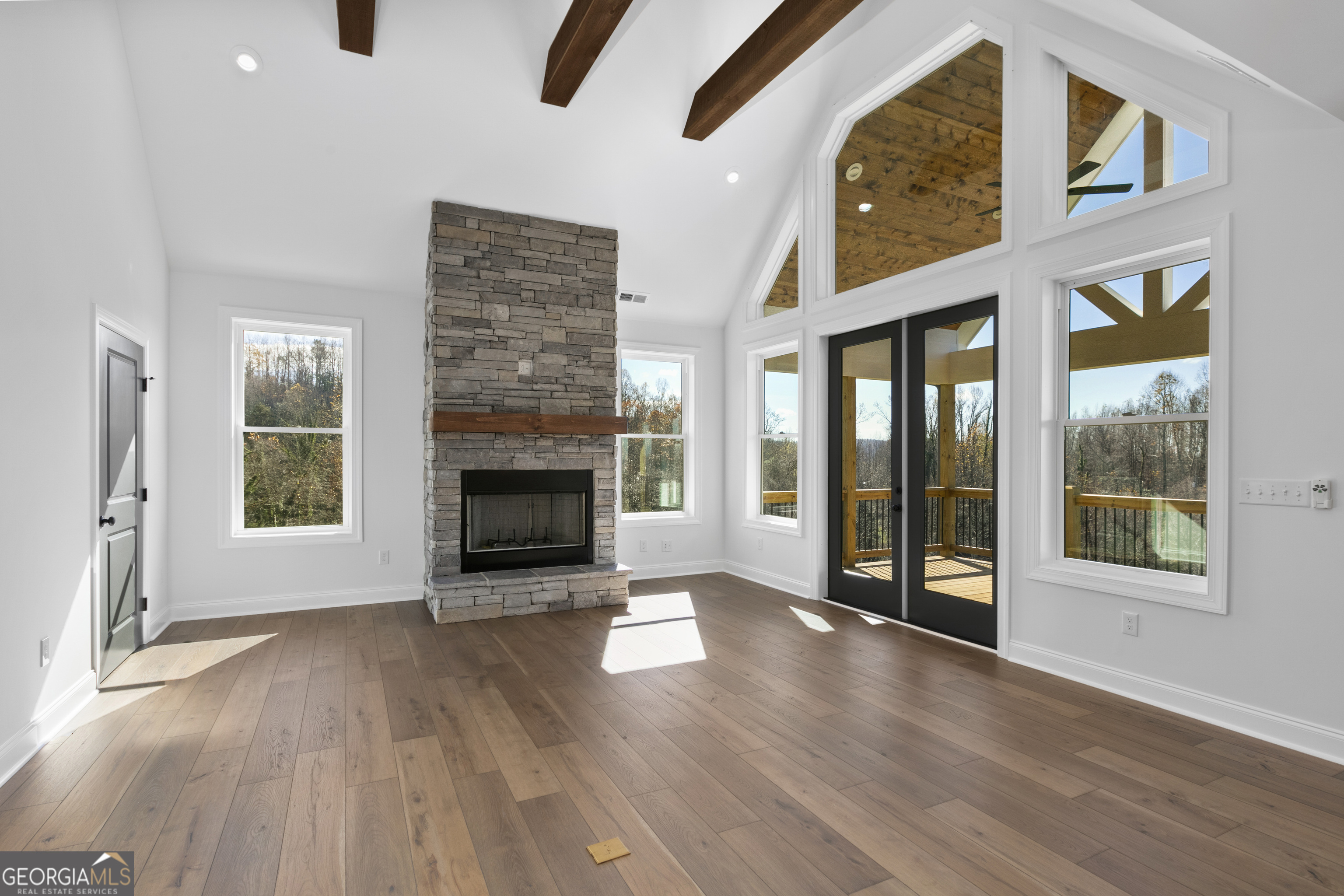 10 Hawks Nest Road, Unit 10 Blairsville, GA 30512 - Photo 13 of 32 an empty room with floor to ceiling windows and fireplace