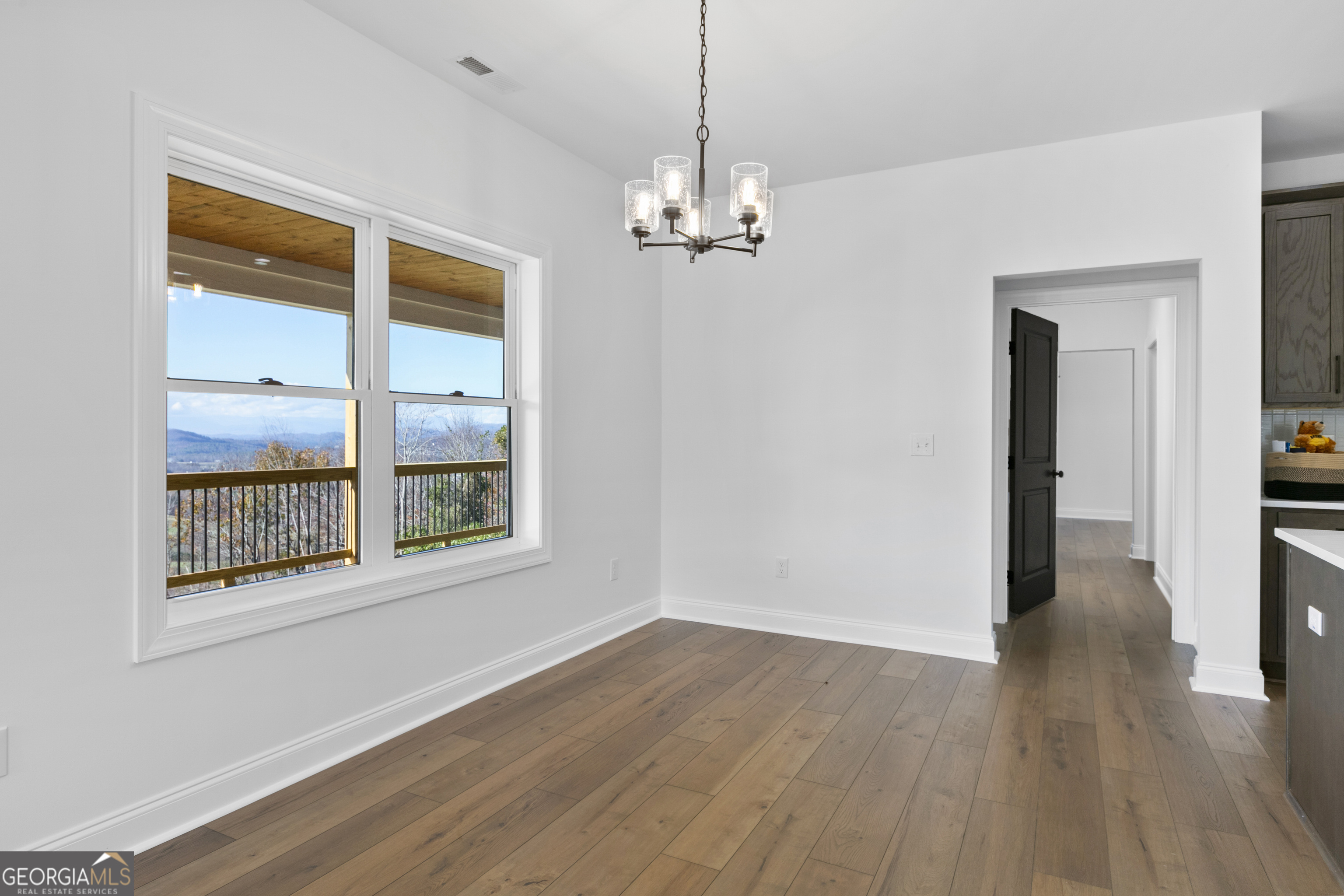 10 Hawks Nest Road, Unit 10 Blairsville, GA 30512 - Photo 17 of 32 a view of empty room with wooden floor and fan