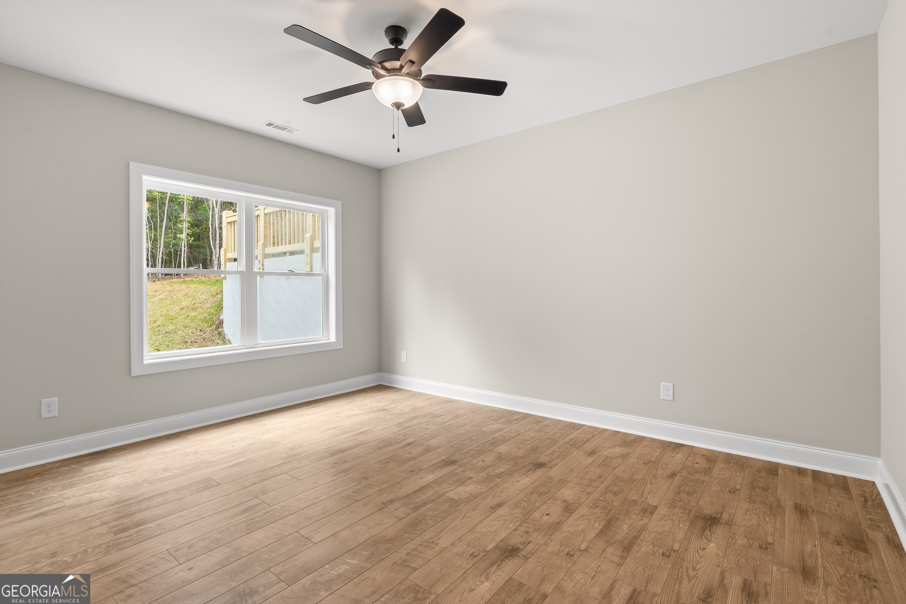 10 Hawks Nest Road, Unit 10 Blairsville, GA 30512 - Photo 22 of 32 an empty room with a window and a fan