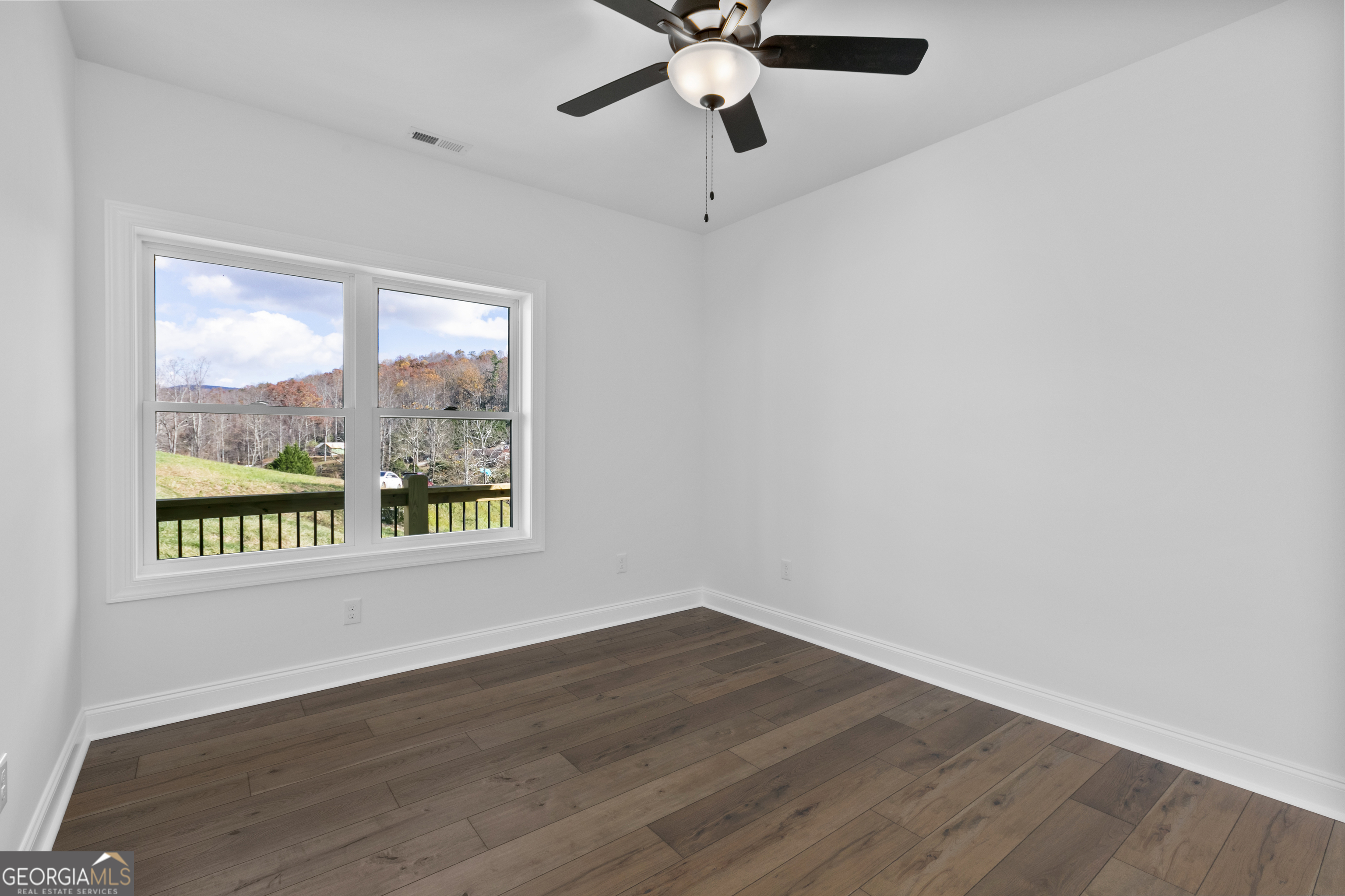 10 Hawks Nest Road, Unit 10 Blairsville, GA 30512 - Photo 28 of 32 a view of an empty room with wooden floor and a window