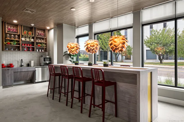 a kitchen with a large window and cabinets