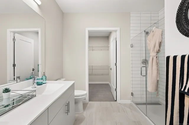 a bathroom with a granite countertop sink toilet and shower
