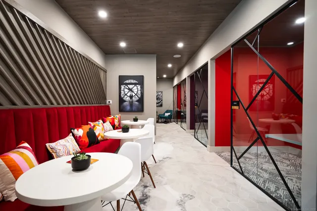 a living room with furniture a rug and white walls
