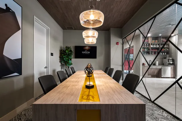 a view of a dining room with furniture and a chandelier