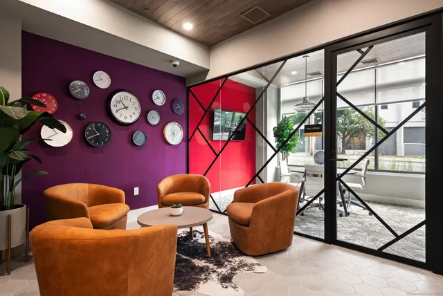 a group of blue chairs sitting in front of a window